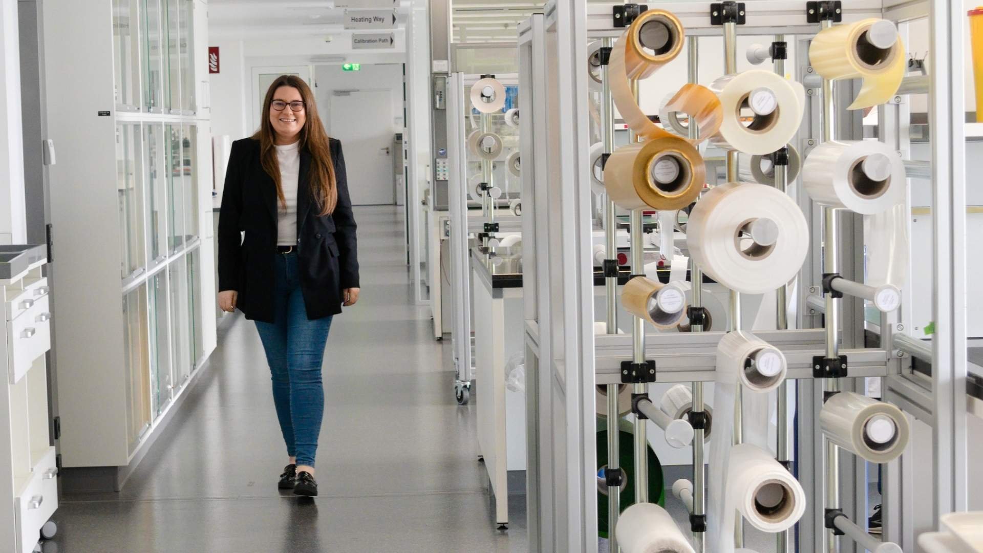 The image shows Dr. Indre Versinkaite in a laboratory environment.