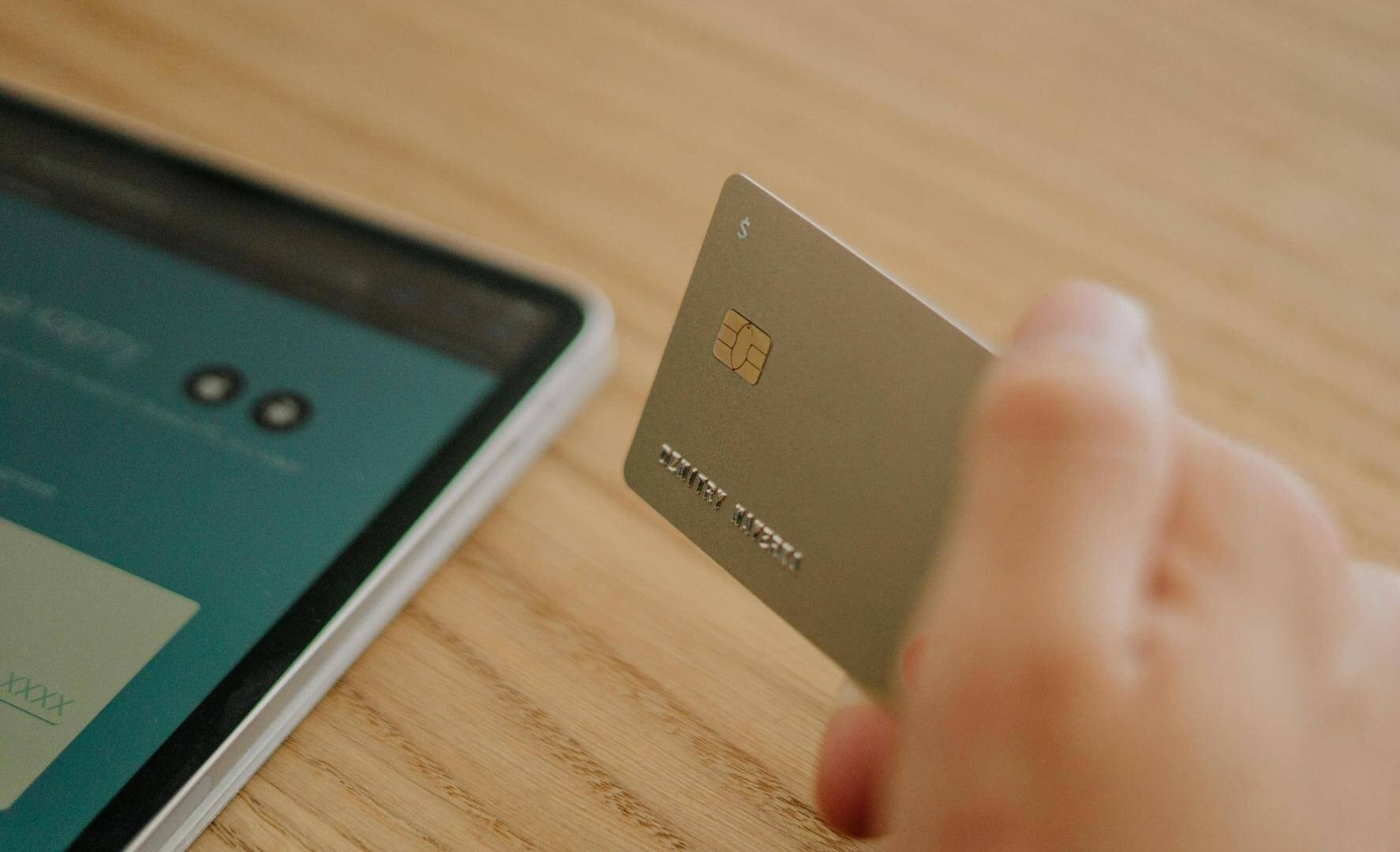 Smart-cards-hand-with-credit-card-tablet-in background