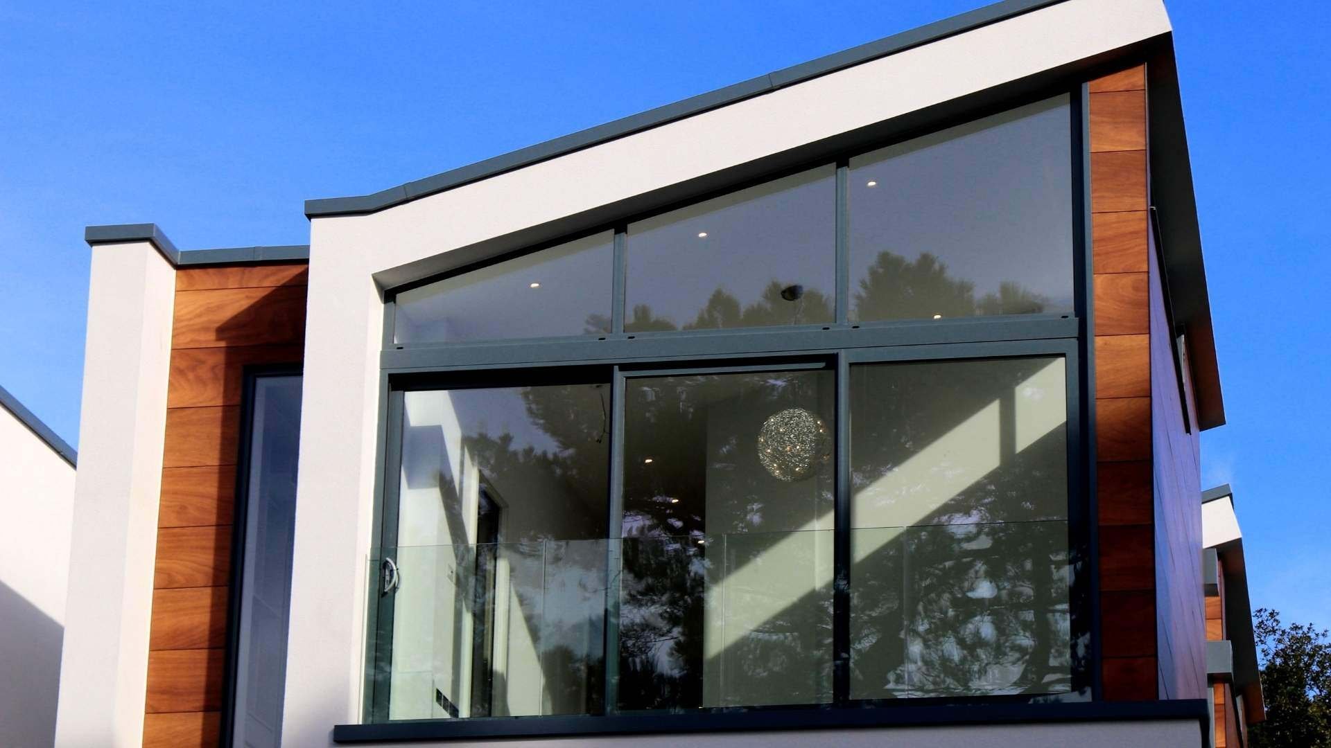 Modern-building-with-large-window-area-against-blue-sky