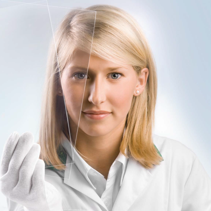 Chemist-looking-through-optically-clear-tapes-left
